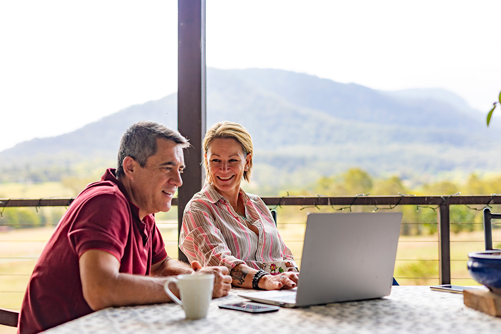 Couple in country looking at laptop