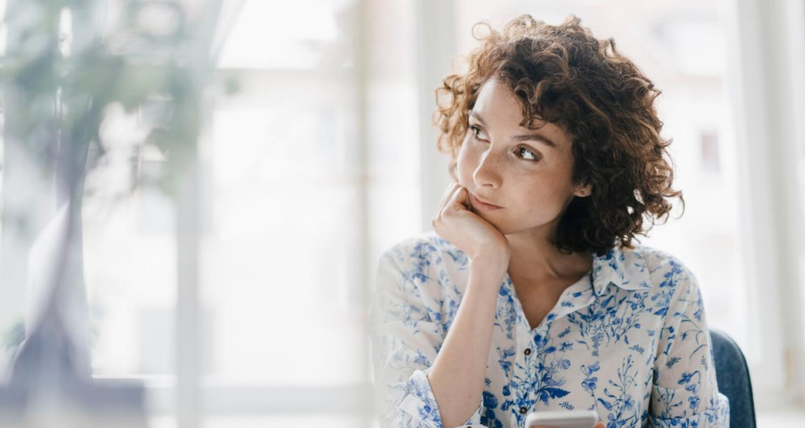 Woman contemplating at desk