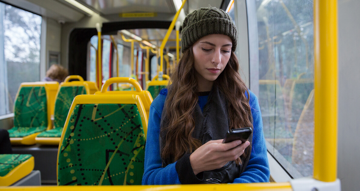 Woman looking at phone on the train