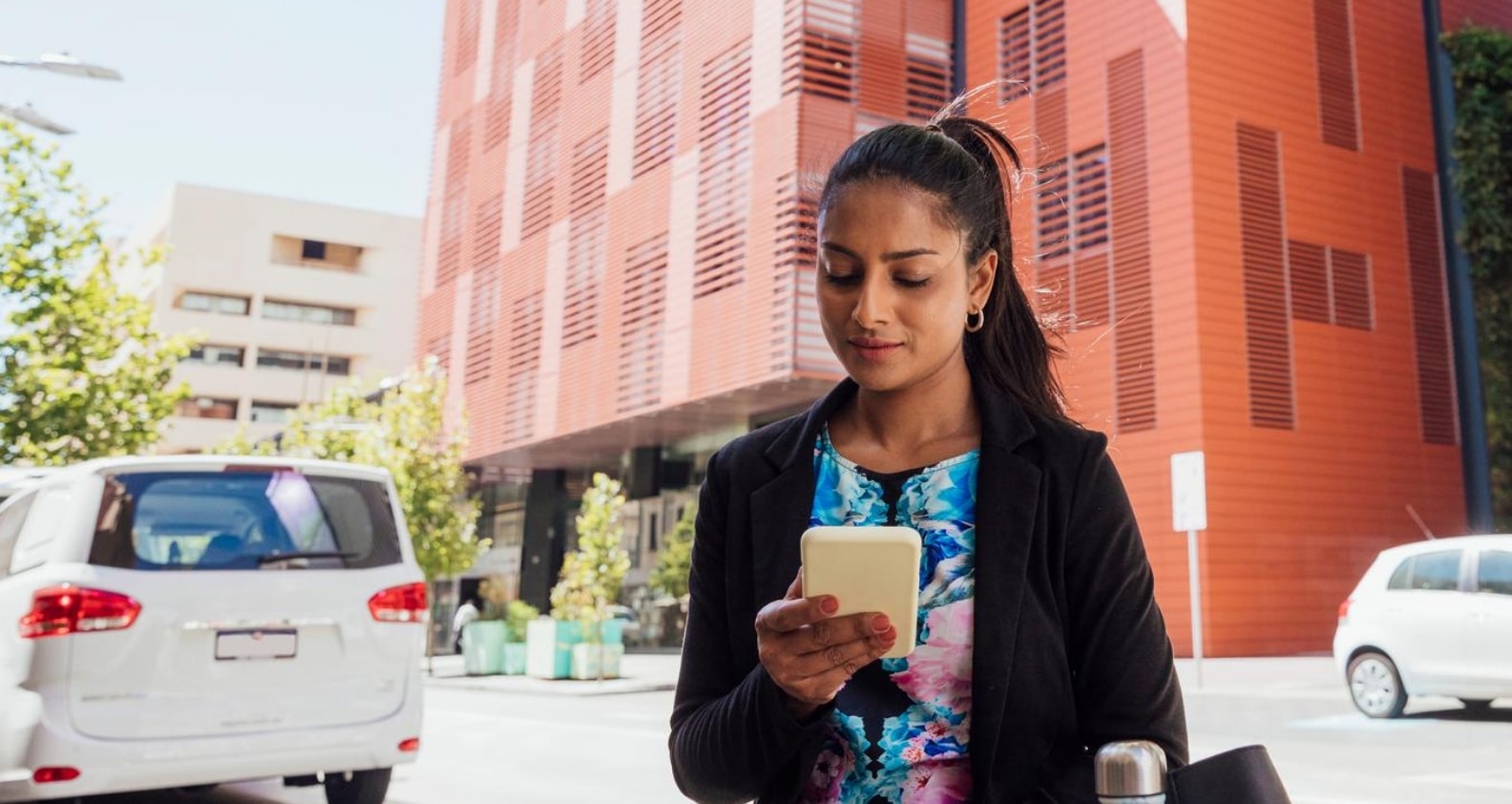 Woman looking at phone on street