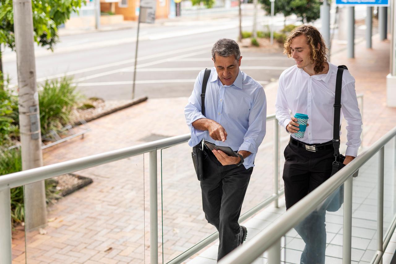Two people walking on ramp